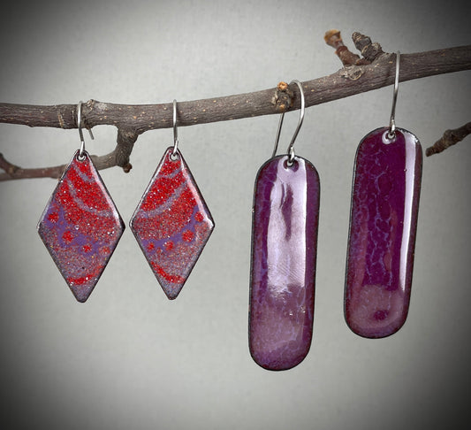 Two pairs of purple marbled earrings hanging on a branch against a gray background. Listing is for earrings on the right.